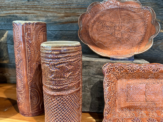 Brown glazed plates, mugs and vases